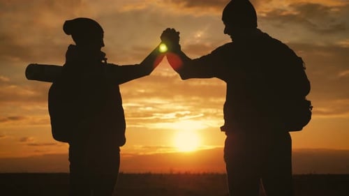 Silhouette of the Team on the Peak of Mountain Sport and Active Life of People Man and Girl