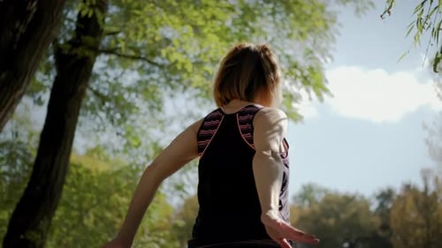 Woman Stretching in the Park on Sunny Day