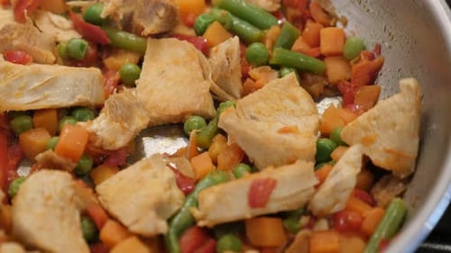 Fresh chicken breasts frying with vegetables 4K 2160p 30fps UltraHD video - Green beans and carrot