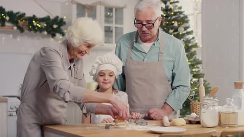 Grandparents and Grandchild Bake Christmas Cookies at Home