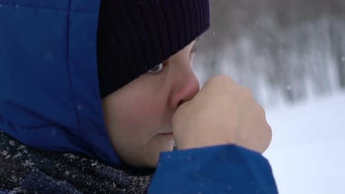 Pensive Child in Snowy Winter Weather