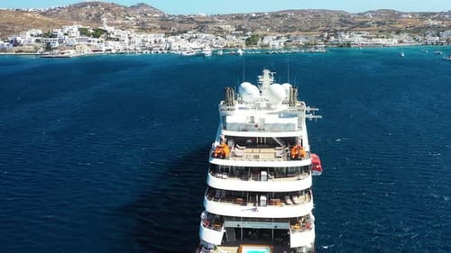 Cruise ship in port. Aerial view of the ship from drone. Blue clear water in the Mediterranean Sea.