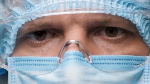 Doctor Puts on Protective Eyewear, Close Up
