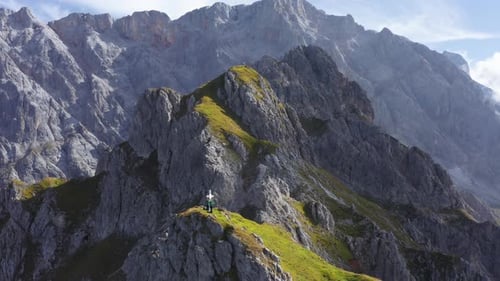 Breathtaking Pull Away Aerial Shot of Rocky Lauskopf Alps and Hikers on Top