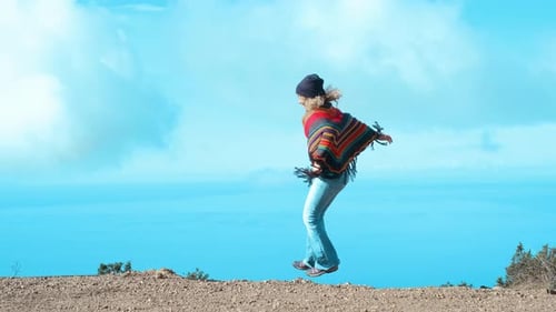 Woman Jumps Happily by Ocean View