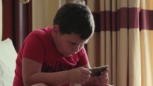 Child Uses Smartphone Device Indoors