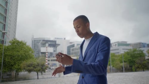 Man Using Mobile Phone Outdoors in Urban Setting