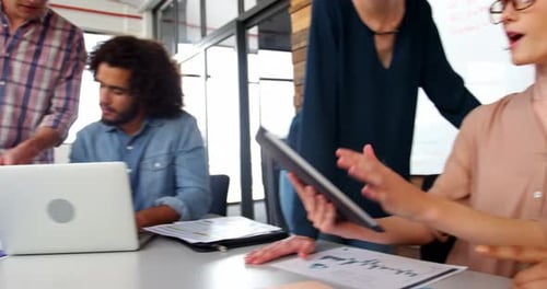 Business Meeting in Modern Office with Tablet