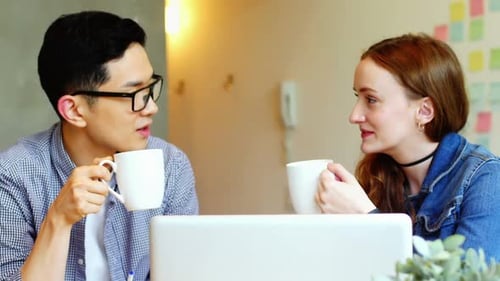 Coworkers Chatting in an Office Setting