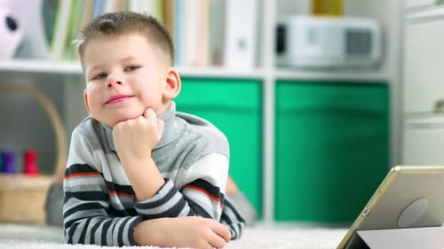 Young Boy Relaxing at Home with Tablet