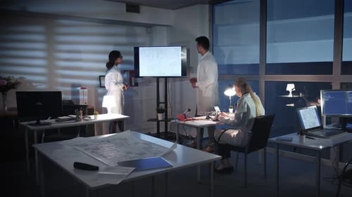 Scientists Collaborate on Technology Project in Modern Office