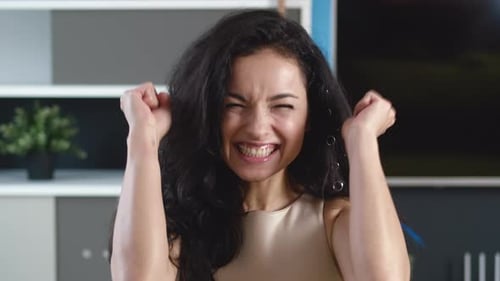 Surprised Excited Young Woman Celebrating Victory Happy Winner at Home Interior Background.
