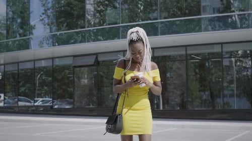 Stylish Woman Using Phone in Urban Setting