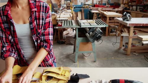 Blonde Woman with Tools in Woodworking Shop