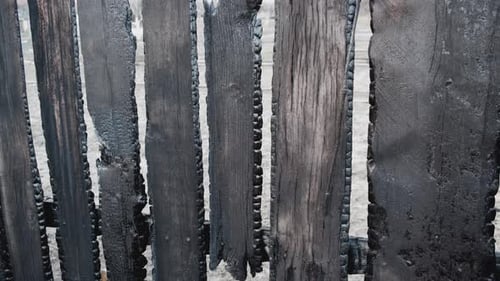 Burnt Fence Boards After a Fire in a Private House