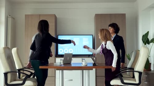 Business Team Meeting and Handshakes in Bright Office