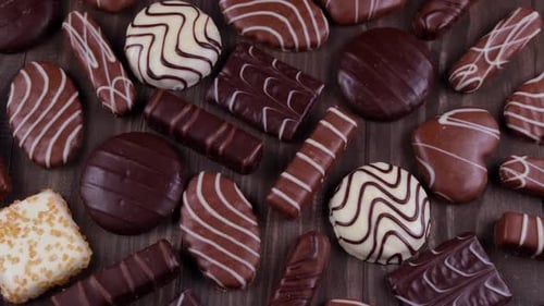 Delicious Assorted Chocolates Arranged on Wooden Surface