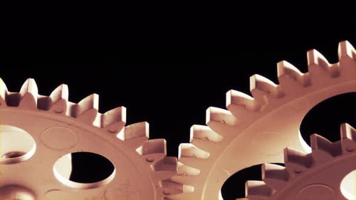 Interlocking Gears Rotating Close Up on Black Background