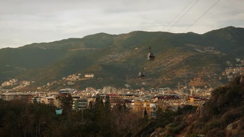 Cable car cabin going down from mountains with cityscape Alanya Turkey