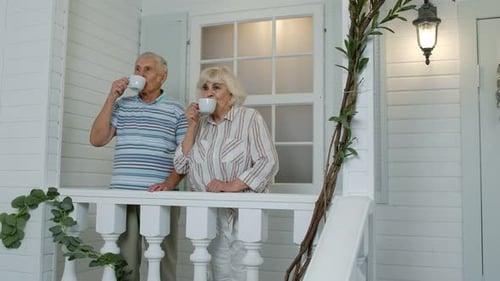 Senior Couple Enjoying Tea on Suburban Home Porch