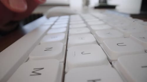 Typing on White Keyboard in a Workplace