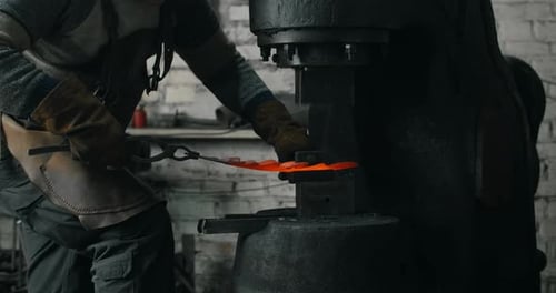 Blacksmith Shaping Metal with Mechanical Forge Press