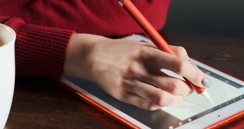 Close Up Female Designer Sitting and Working at Desk. Contemporary Young Woman Drawing and Using Pen