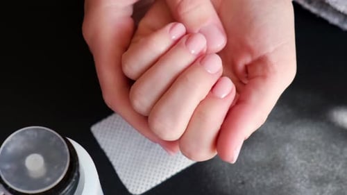 Hands Cleaning Freshly Manicured Nails Close Up