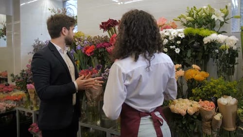 Customer Discussing Flowers with Employee in Flower Shop