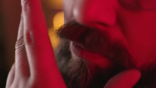 Extreme Close Up of Man with Beard in Red Light