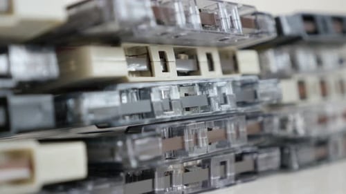 Tilting on retro analogue magnetic tapes stacked 4K 2160p 30fps UltraHD footage - Close-up of music