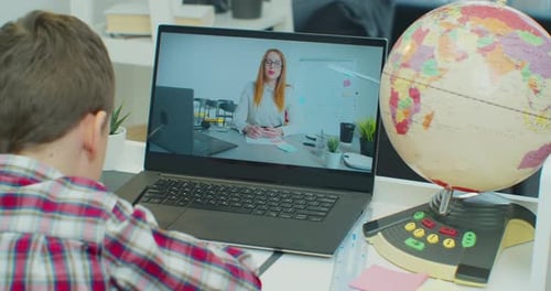 Boy Attends Online School Lesson at Home