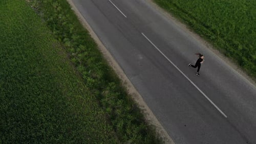 A Young Woman Running Down the Road