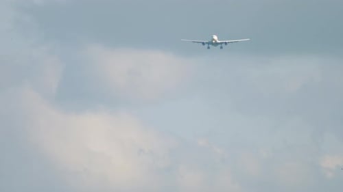 Passenger Airplane Approaching in Overcast Sky