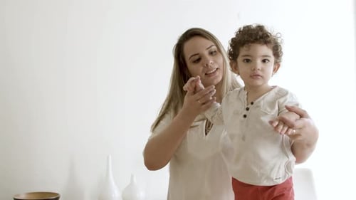 Cute Little Boy Holding Moms Hands Learning How to Walk