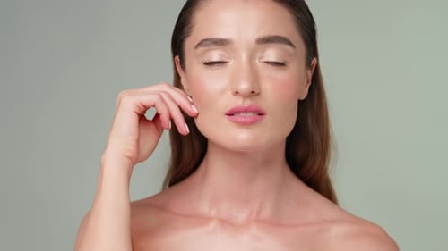 Woman Touches Her Face and Smiles