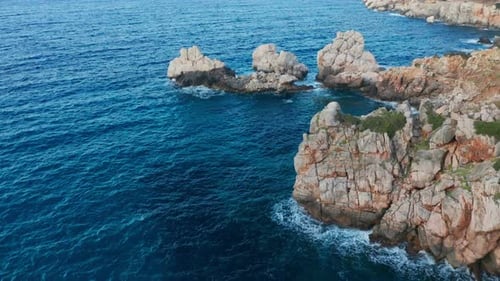 Drone Over Offshore Rock Formations In Blue Mediterranean Sea