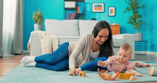 Mother and Infant Play with Wooden Blocks at Home