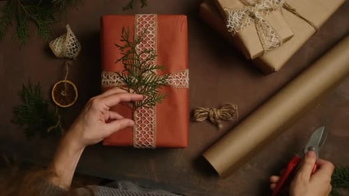 Young Woman Decorating Christmas Present