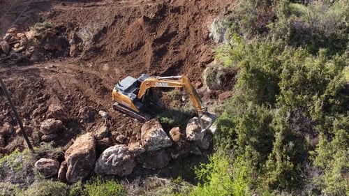 Excavator Digging Into Hillside in Rural Area