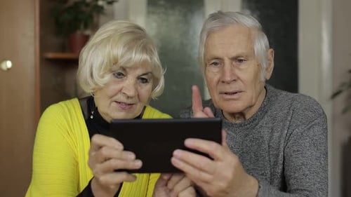 Senior Couple Using Tablet Technology Together at Home