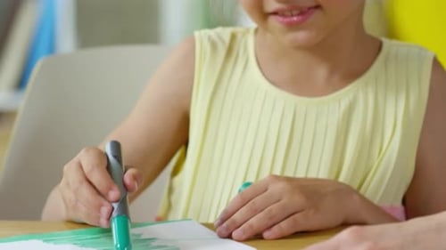 Pretty Little Girl Drawing on Paper with Felt Tip Pen