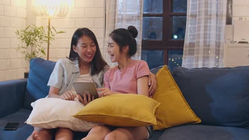 Young Women Using Tablet Together at Home