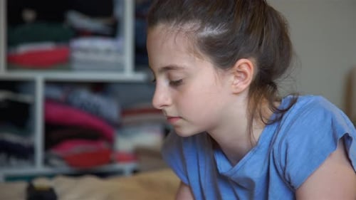 Girl Using Laptop Computer While Lying on Bed
