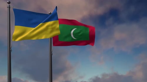Flags of Ukraine and Maldives Waving Against Blue Sky