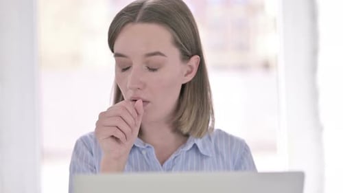Portrait of Sick Young Woman Coughing in Office
