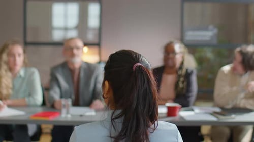 Recruitment Committee Interviewing Female Candidate in Office