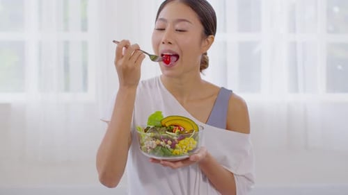 Woman Eating Colorful Salad Indoors