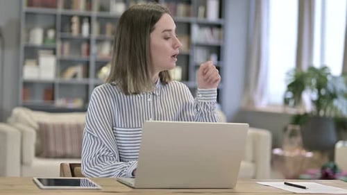 Sick Young Woman Coughing in Loft Office