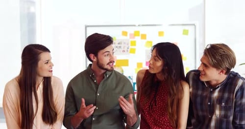 Smiling Young Adults Brainstorming in Modern Workplace